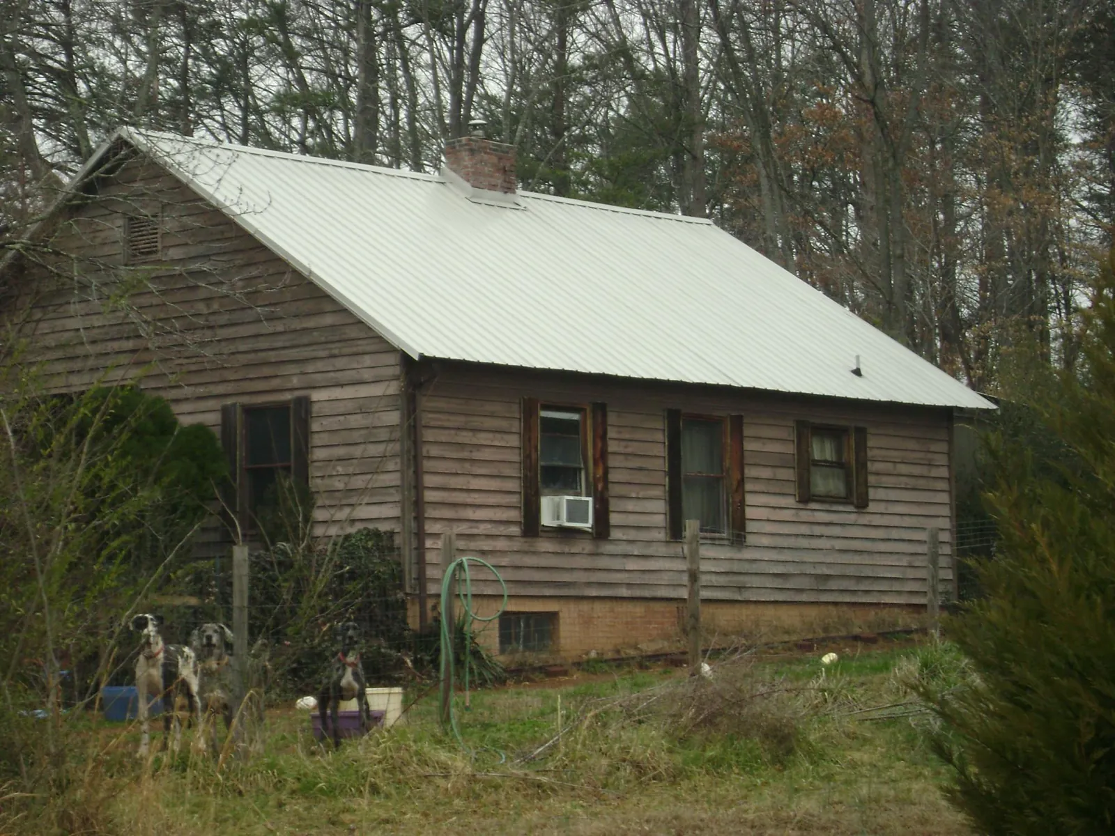 White metal roof on an old wood sided farmhouse, from a Metal Roof Installation job in Black Lick